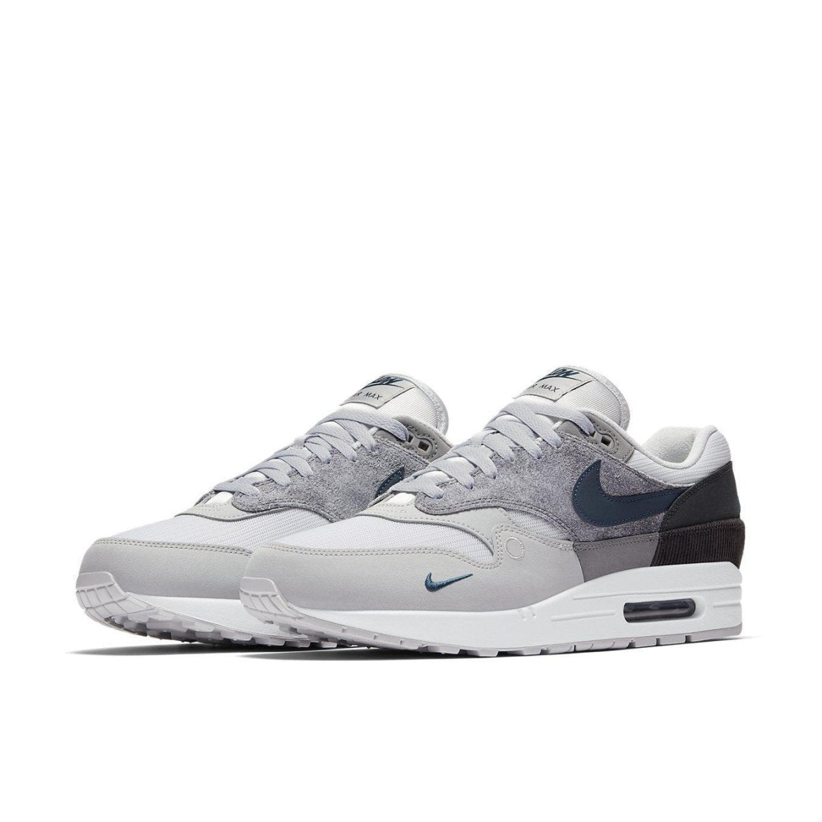 Nike Air Max 1 London sneakers in gray and blue, showcasing a blend of textures and urban design.
