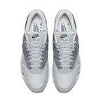 Nike Air Max 1 London sneakers showcasing a grey and white colorway with suede materials for an urban style.