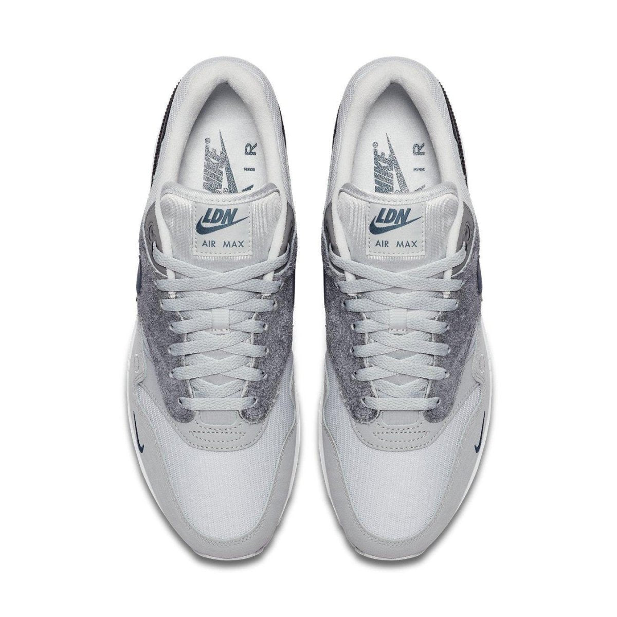 Nike Air Max 1 London sneakers showcasing a grey and white colorway with suede materials for an urban style.
