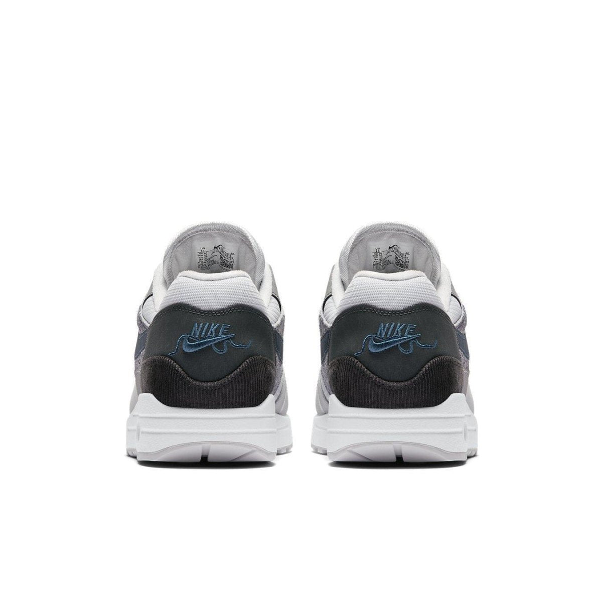 Nike Air Max 1 London sneakers in grey and black with blue logo, showcasing urban design elements.