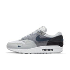Nike Air Max 1 London sneaker featuring shades of grey and suede materials, inspired by London's urban environment.