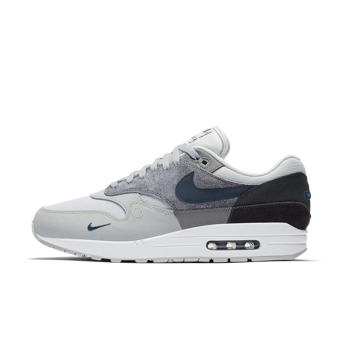 Nike Air Max 1 London sneaker featuring shades of grey and suede materials, inspired by London's urban environment.