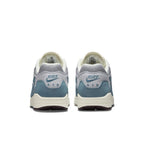 Rear view of Nike Air Max 1 Patta Waves Noise Aqua, featuring gray mesh and blue suede details.