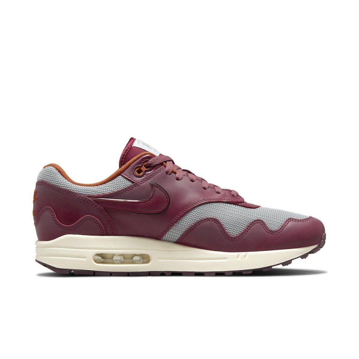 Nike Air Max 1 Patta Waves in Rush Maroon with grey mesh, smooth brown leather, and wave-shaped overlays.