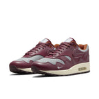 Nike Air Max 1 Patta Waves Rush Maroon sneaker featuring gray mesh and smooth brown leather overlays.