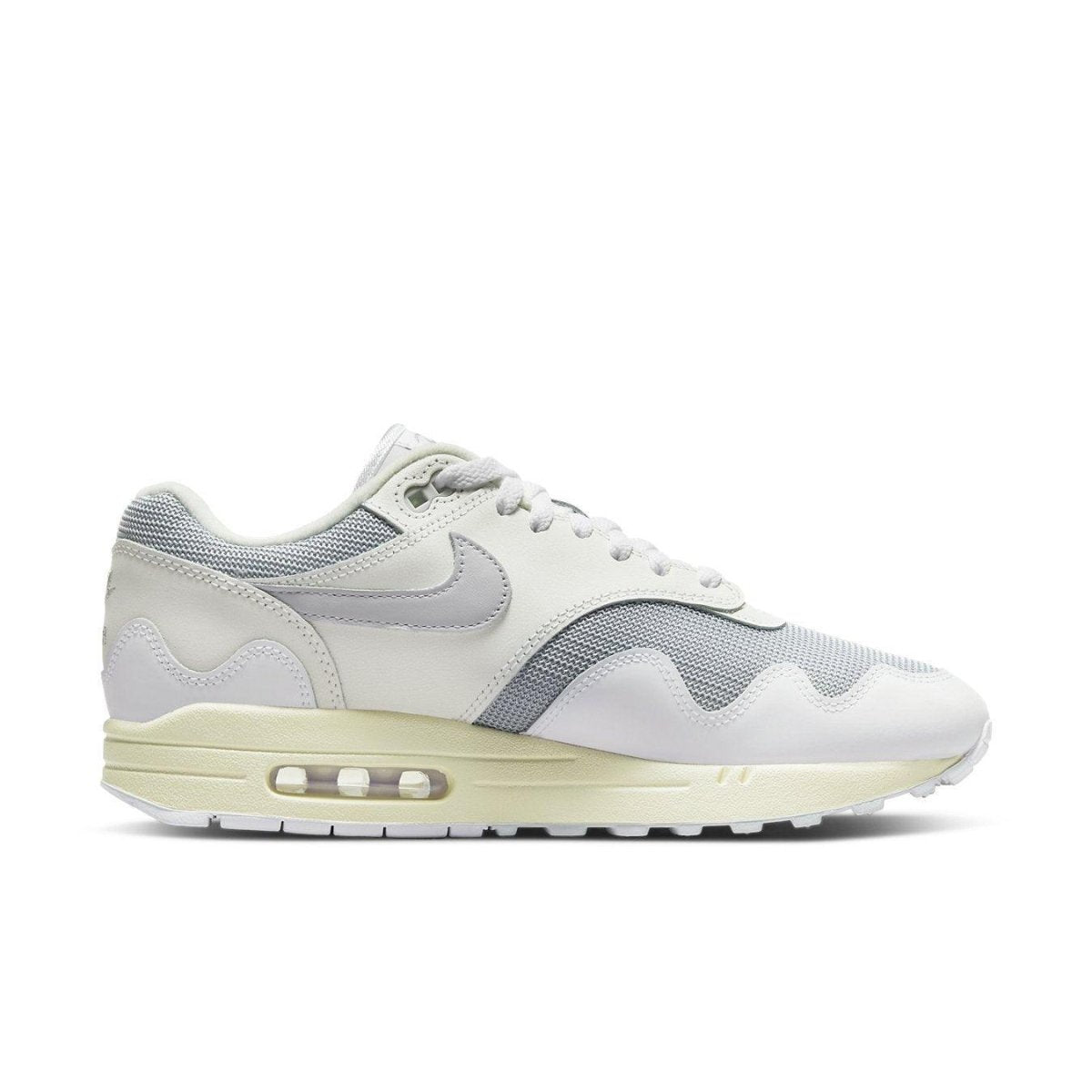 Nike Air Max 1 Patta Waves in metallic silver and white, featuring wave design and mesh detailing.
