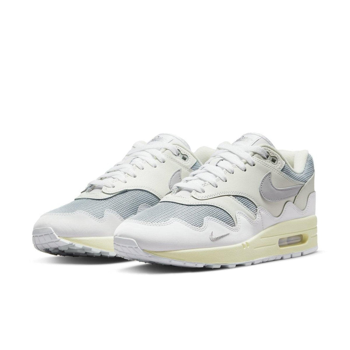 Nike Air Max 1 Patta Waves in metallic silver and white, featuring a stylish wavy design.