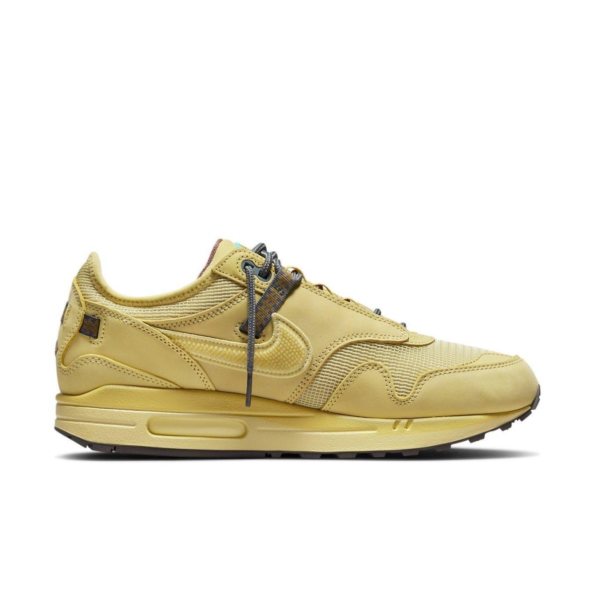 Nike Air Max 1 Travis Scott 'Saturn Gold' sneakers featuring a monochrome yellow mesh and leather upper.