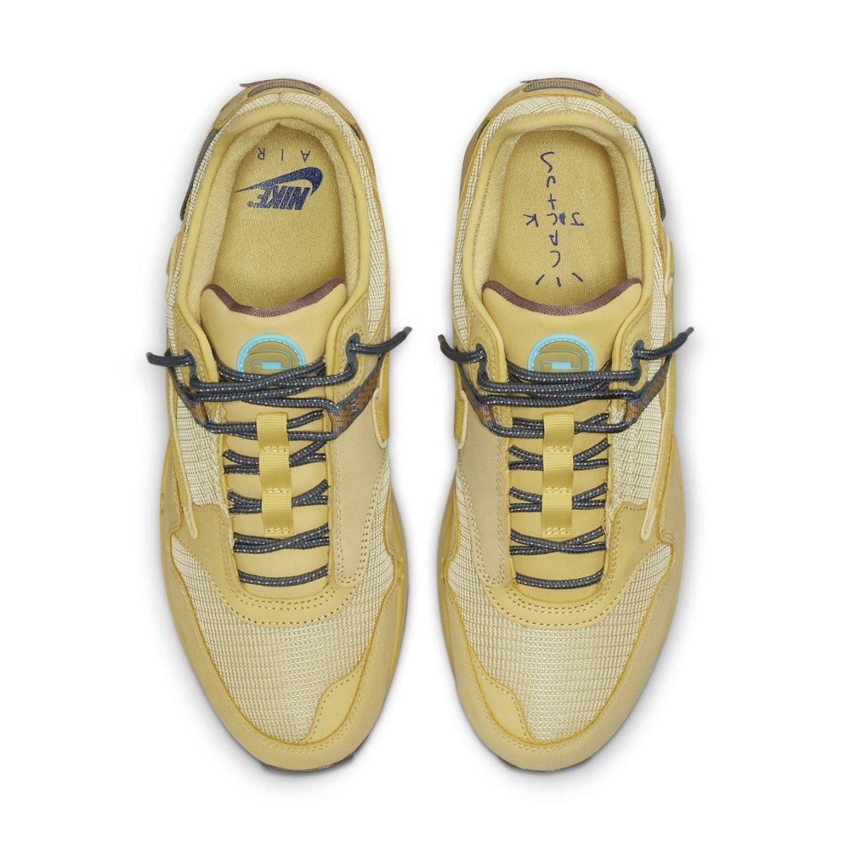 Nike Air Max 1 Travis Scott 'Saturn Gold' sneakers featuring yellow mesh and leather upper with distinctive lacing.