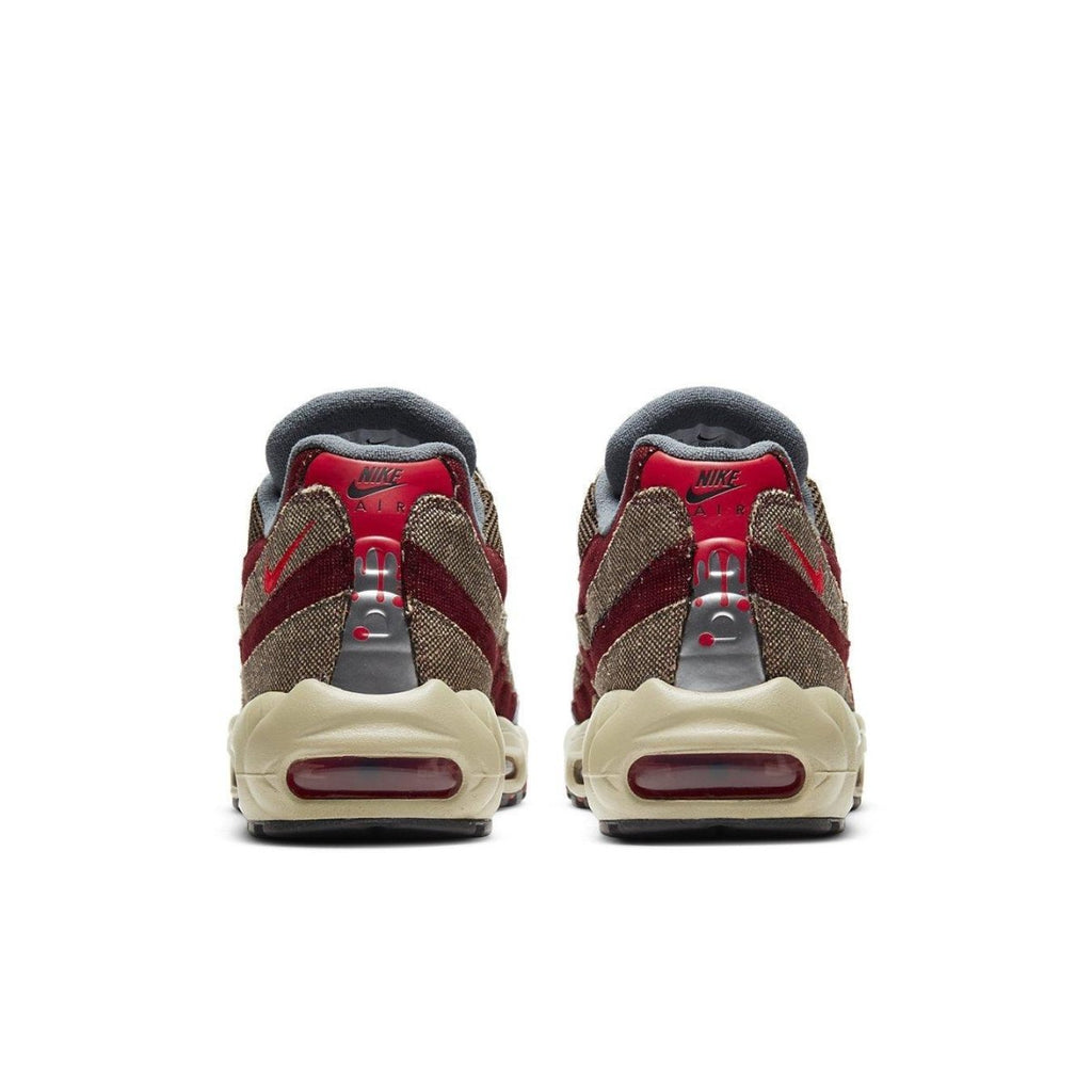 Nike Air Max 95 Freddy Krueger sneakers, featuring red and brown striped design inspired by Halloween.