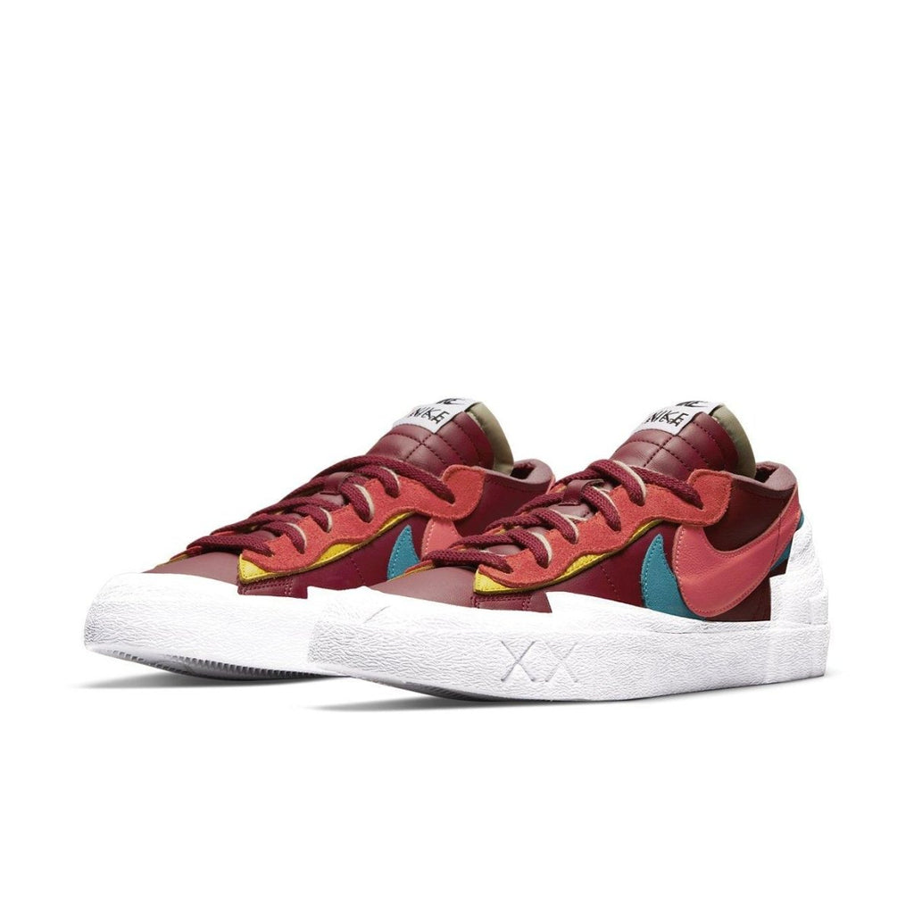 Nike Blazer Low sacai KAWS in red with contrasting colors and unique double-layered design.