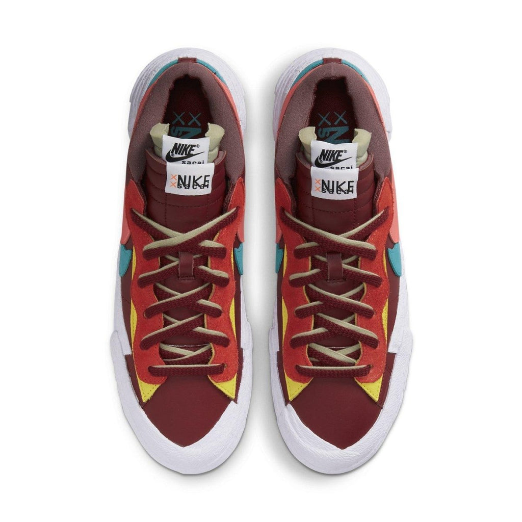 Nike Blazer Low Sacai KAWS in red with contrasting colors and dual laces, showcasing a unique design collaboration.