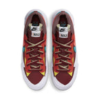 Nike Blazer Low Sacai KAWS in red with contrasting colors and dual laces, showcasing a unique design collaboration.