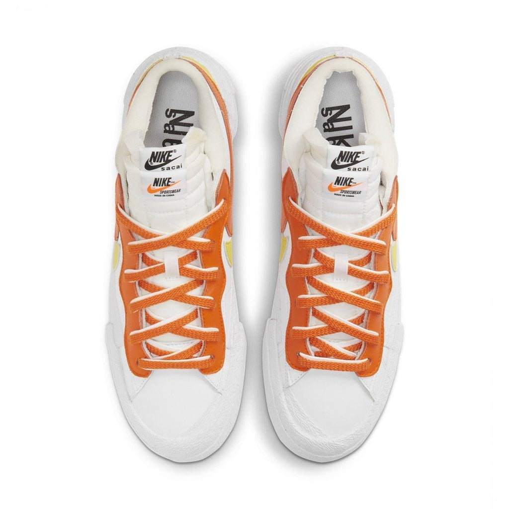 Nike Blazer Low sacai in White and Magma Orange, featuring layered Swooshes and unique double lacing design.