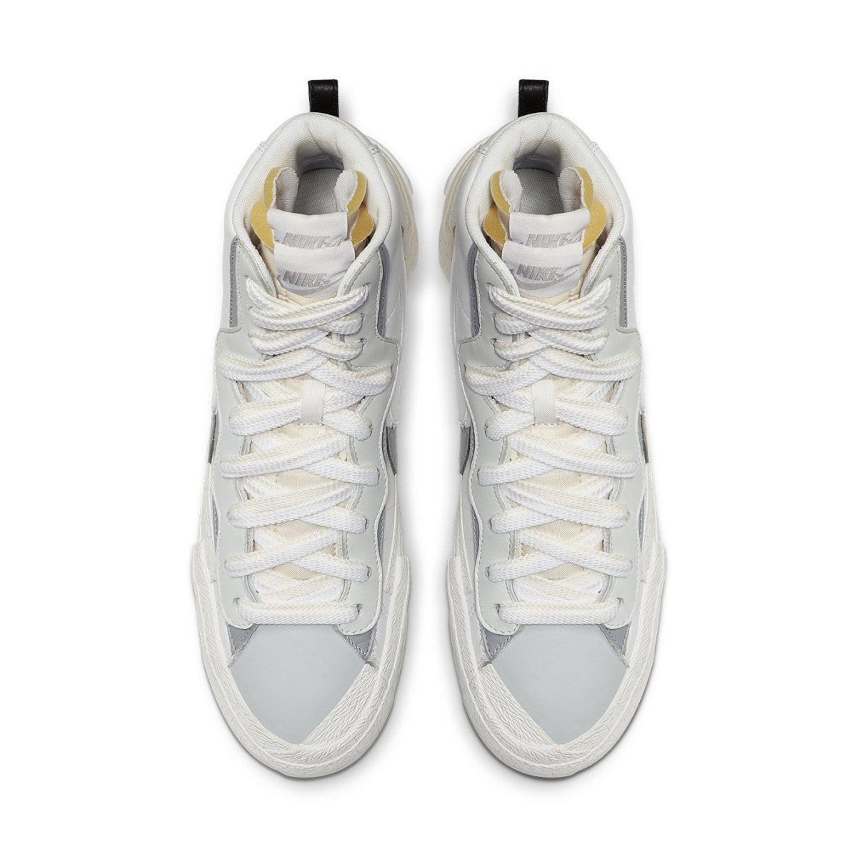 Nike Blazer Mid sacai in white and grey, featuring double Swoosh design and unique lace-up style from above.