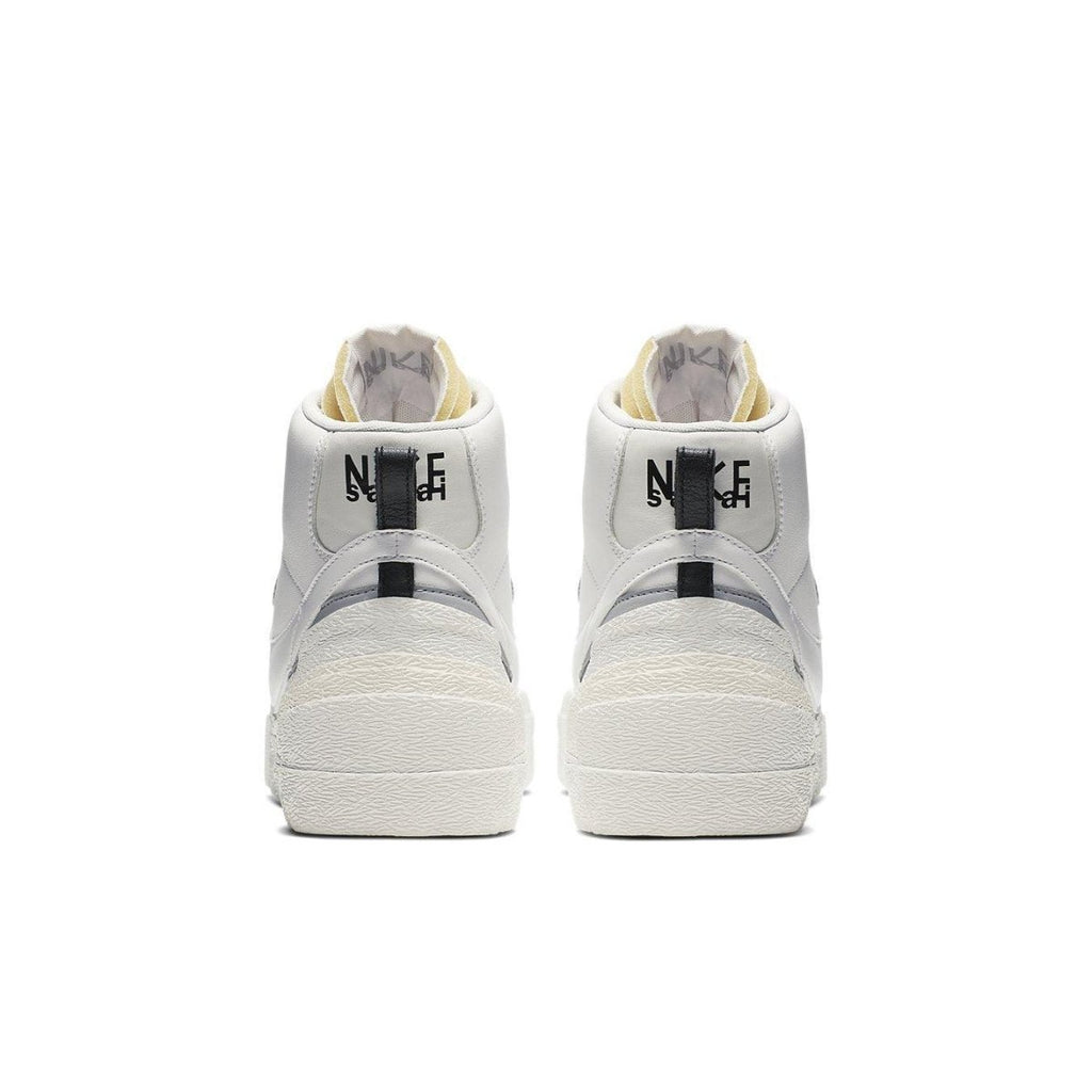Back view of Nike Blazer Mid sacai White Grey sneakers showcasing two Swoosh designs and stylish high-top silhouette.