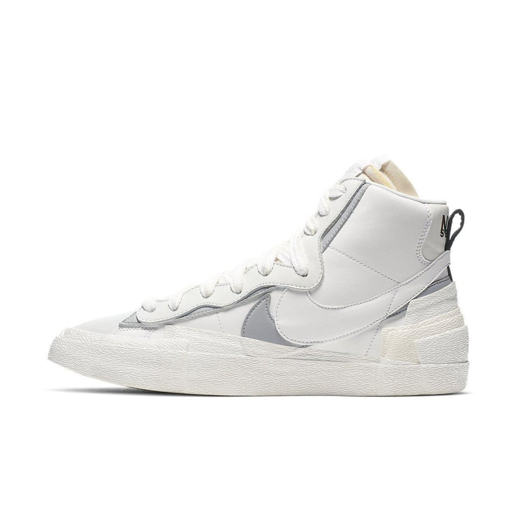 Nike Blazer Mid sacai in white and grey, featuring double Swoosh design for a stylish sneaker look.