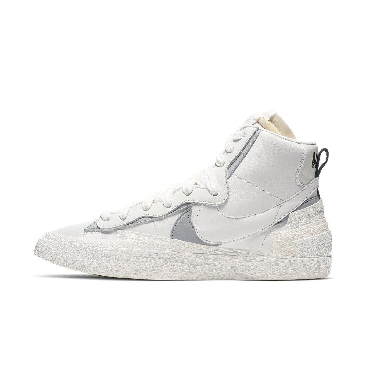Nike Blazer Mid sacai in white and grey, featuring double Swoosh design for a stylish sneaker look.