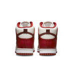 Nike Dunk High LXX Cinnabar women’s sneakers, rear view showcasing red and white color scheme with stylish design.
