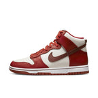 Nike Dunk High LXX Cinnabar (W) sneaker in red and white colorway, featuring high-top design and classic Nike branding.