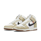 Nike Dunk High Retro Toasty Rattan shoes with quilted upper and black swoosh, ideal for outdoor adventures.