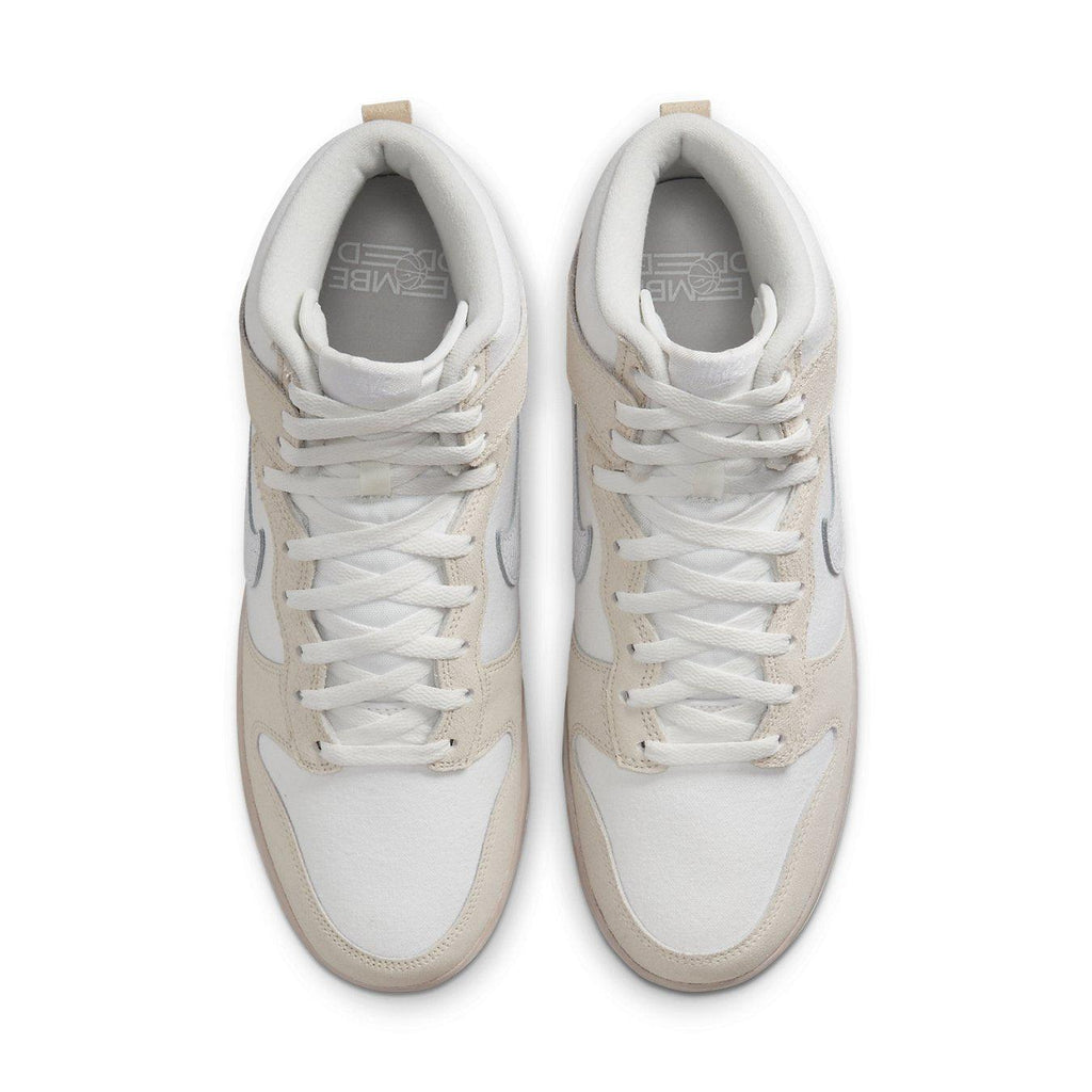Top view of Nike Dunk High Retro PRM sneakers in cracked leather, featuring light pink and white design.