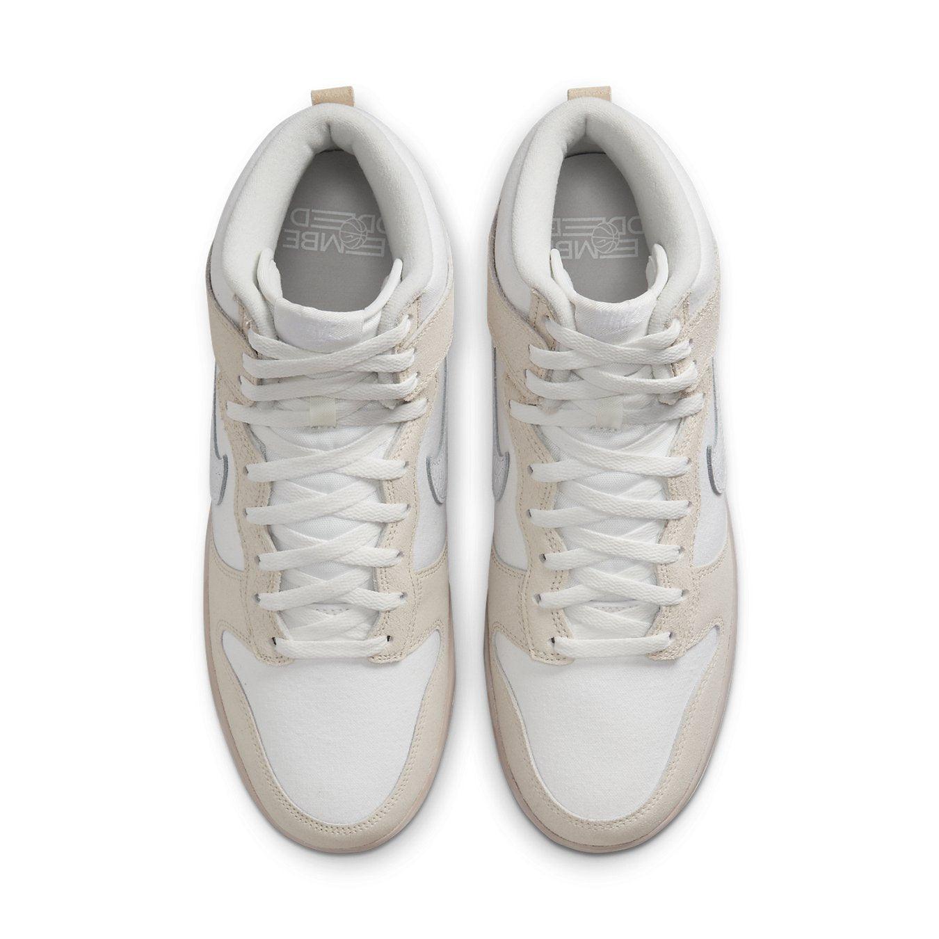 Top view of Nike Dunk High Retro PRM sneakers in cracked leather, featuring light pink and white design.