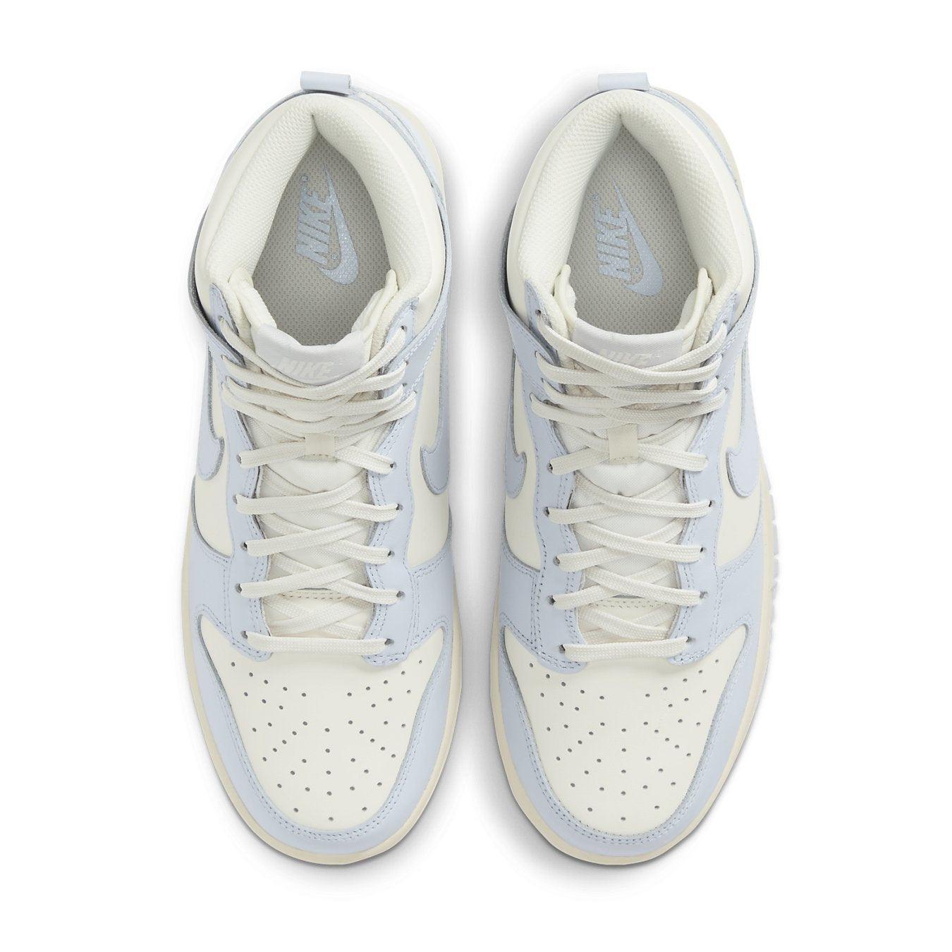 Nike Dunk High Sail Football Grey (W) sneakers in cream and light blue colorway, featuring Swoosh logos and perforated design.
