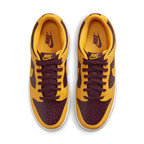 Nike Dunk Low Arizona State sneaker in yellow and burgundy colorway, featuring laces and iconic Nike branding.