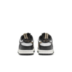 Nike Dunk Low Black White Metallic (GS) rear view showing black and white colorway with metallic details.