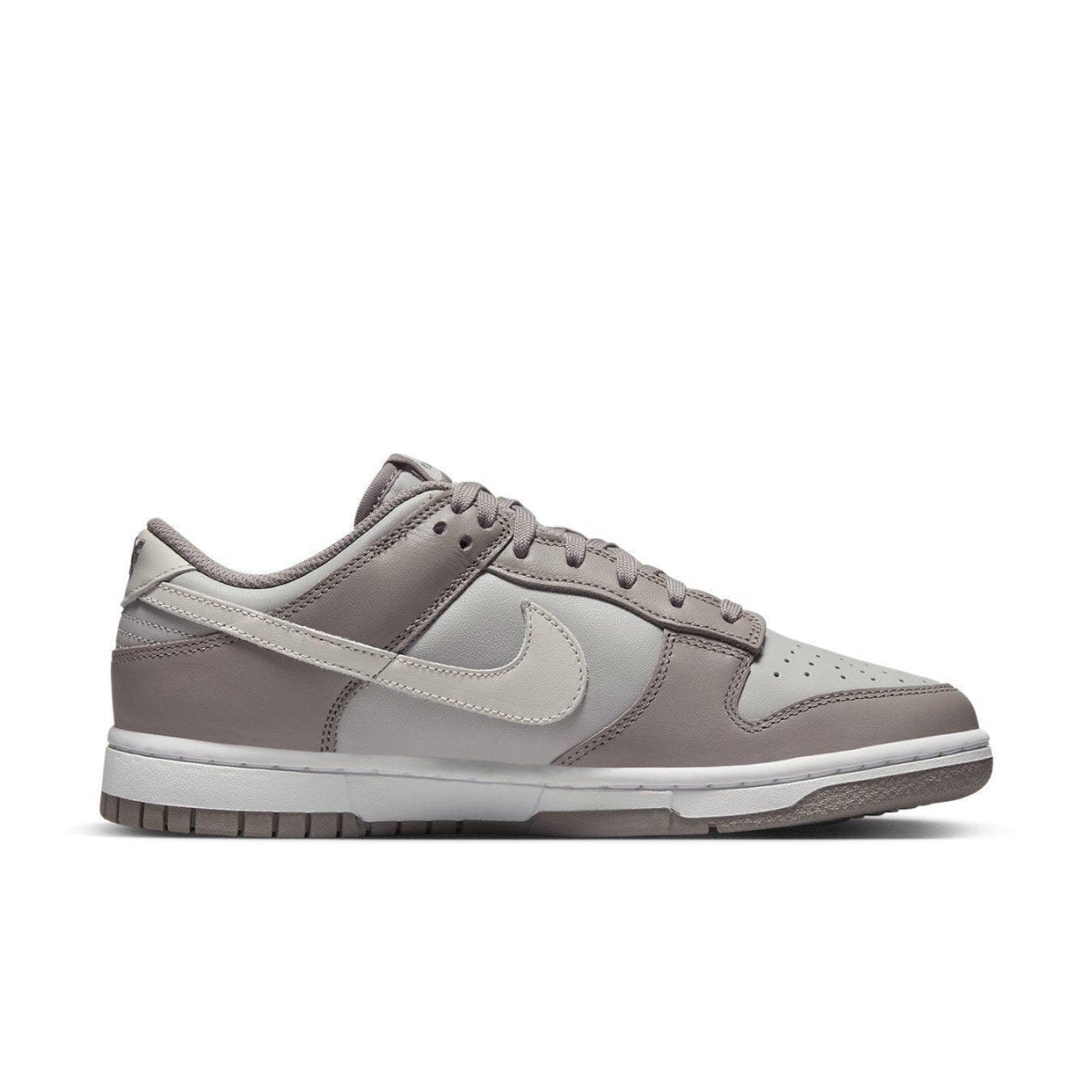 Nike Dunk Low Bone Beige (W) sneakers in light grey and tan colorway with classic leather construction.