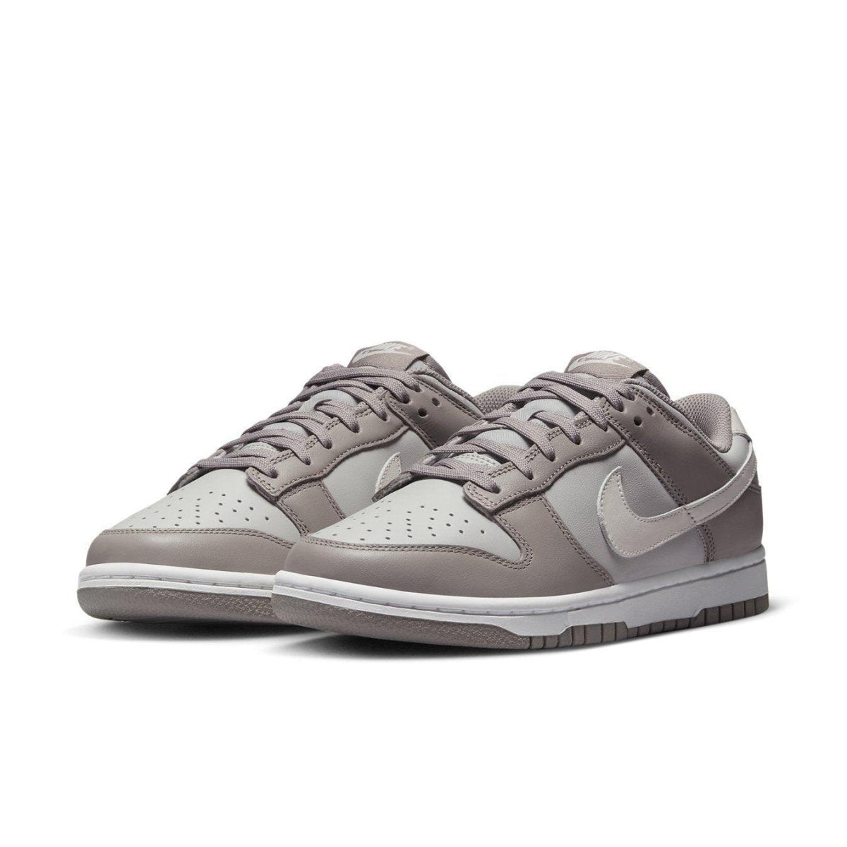Nike Dunk Low Bone Beige sneakers in light bone and tan colorway with leather construction.