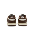 Nike Dunk Low Cacao Wow Women's sneakers with brown accents and white details from the back view.