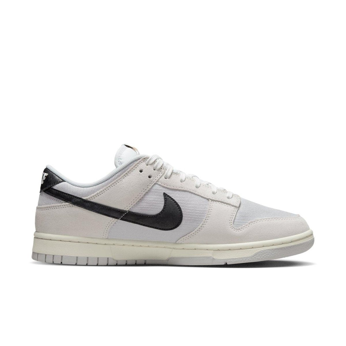 Nike Dunk Low Certified Fresh sneaker in white mesh and beige suede with black Swoosh, side view.
