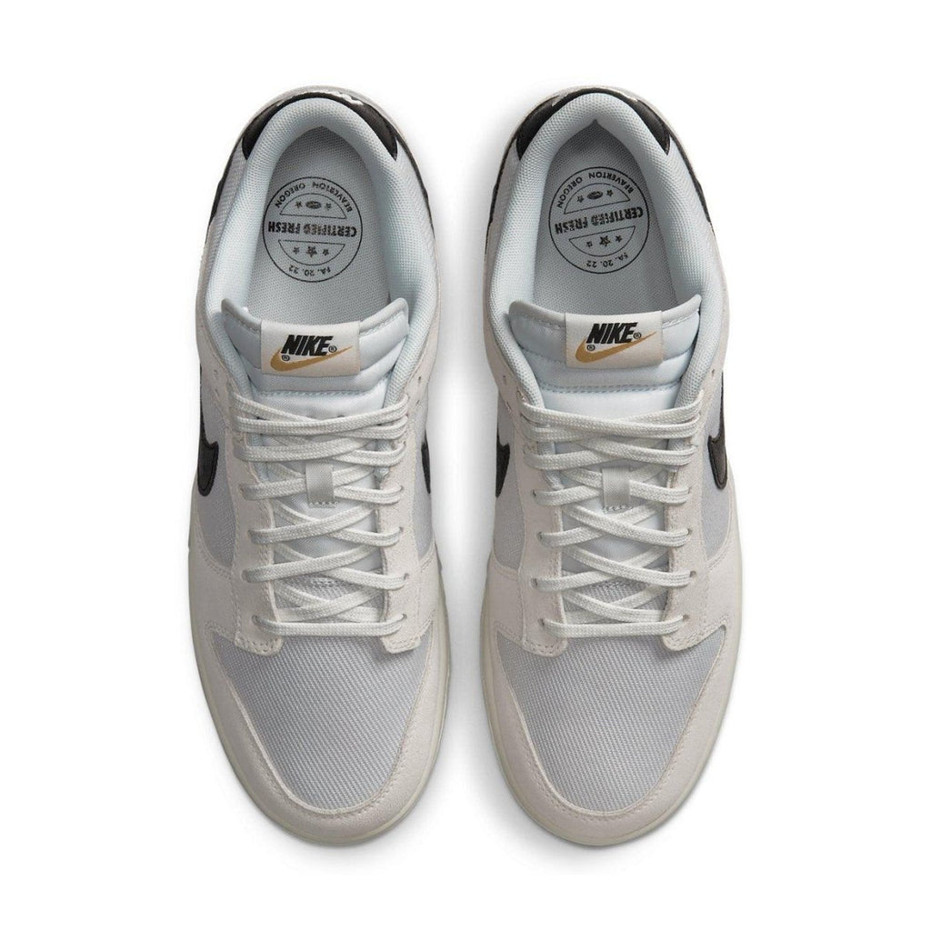 Nike Dunk Low Certified Fresh sneaker in white mesh and beige suede with black Swoosh, top view.