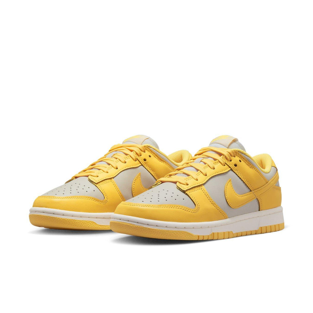 Nike Dunk Low Citron Pulse women's sneakers with yellow and grey leather upper and classic lace closure.