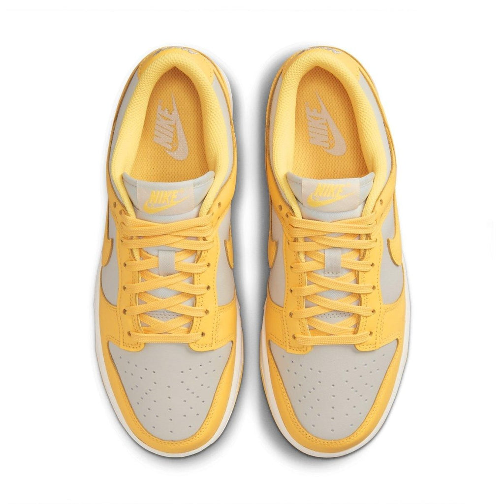 Nike Dunk Low Citron Pulse (W) sneaker in yellow and beige, featuring perforated toe and padded insole for comfort.