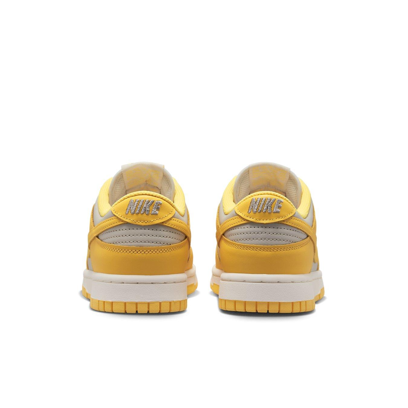 Nike Dunk Low Citron Pulse (W) shoes in yellow with leather upper and perforated toe for ventilation.
