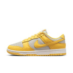 Nike Dunk Low Citron Pulse women's sneaker in yellow and gray with perforated toe and classic lacing for a custom fit.