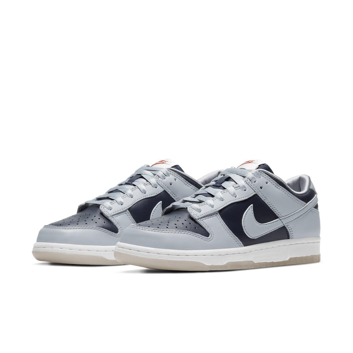 Nike Dunk Low College Navy Grey (W) sneakers in navy and grey colorway, featuring a sleek design and classic style.