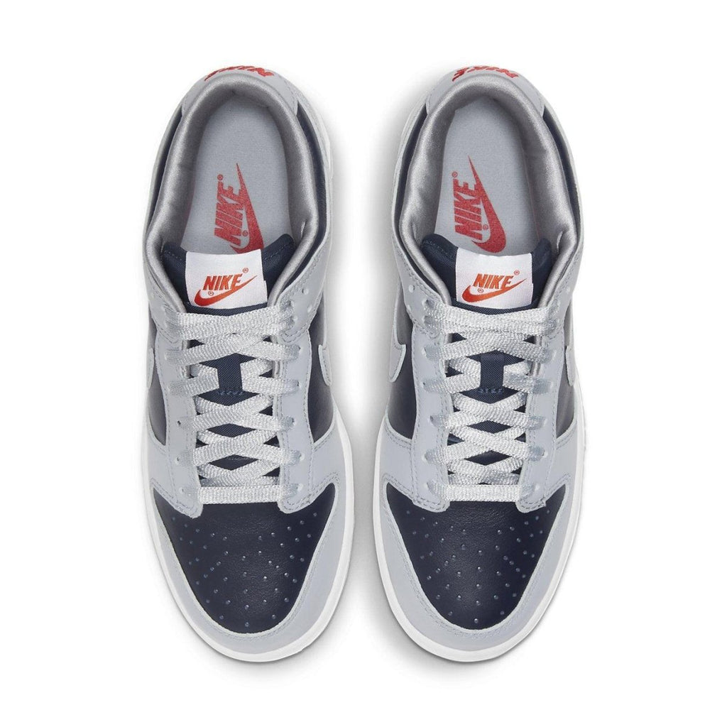 Nike Dunk Low College Navy Grey (W) top view showing navy and grey colorway with perforated toe and branded details.