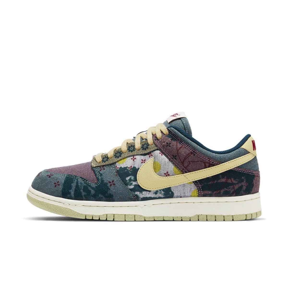 Nike Dunk Low Community Garden sneaker featuring earth tones and patchwork design in a low-top style.