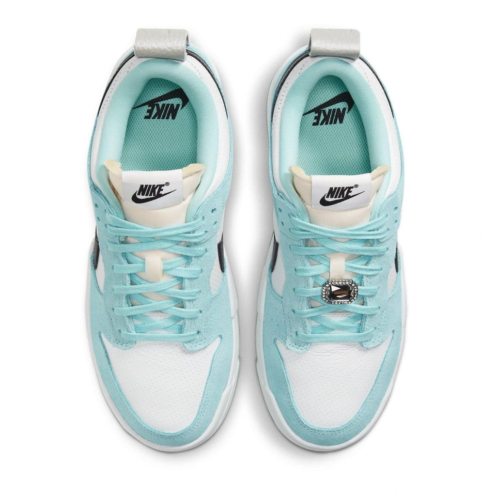 Nike Dunk Low Disrupt Copa sneakers in white, light blue, and black with silver detailing, top view.