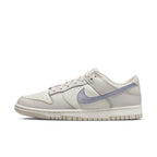 Nike Dunk Low ESS Sail Oxygen Purple women's sneaker in premium white leather with metallic purple Swoosh.