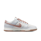 Nike Dunk Low Fossil Rose sneaker featuring beige suede, pastel pink accents, and grayish-blue details.