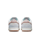 Nike Dunk Low Fossil Rose sneakers rear view featuring beige suede and pastel pink accents.