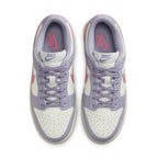 Top view of Nike Dunk Low Indigo Haze women's sneakers featuring cream and indigo panels with pink Swoosh.