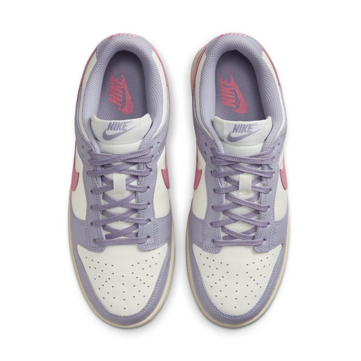 Top view of Nike Dunk Low Indigo Haze women's sneakers featuring cream and indigo panels with pink Swoosh.