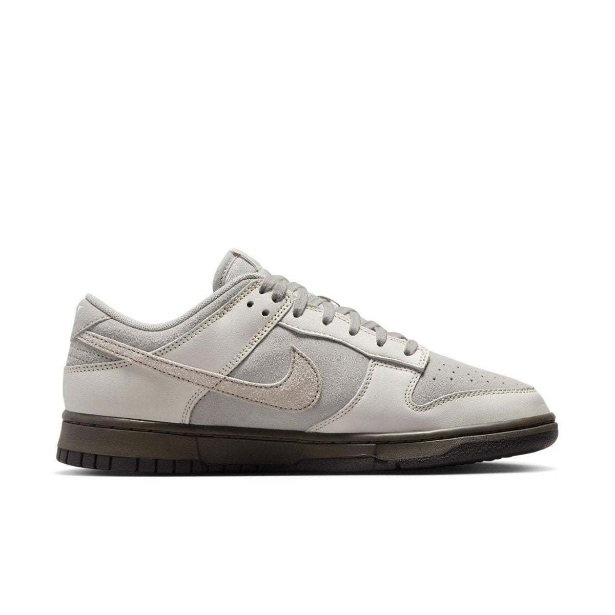 Nike Dunk Low Ironstone sneaker in gray tones with chocolate sole, showcasing a stylish and modern design.