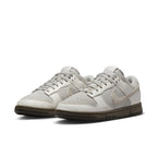 Nike Dunk Low Ironstone sneakers featuring a light upper and chocolate outsole for a stylish look.